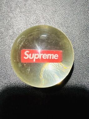 Supreme Red Logo in a clear bouncy ball. Great gift for Supreme collectors.